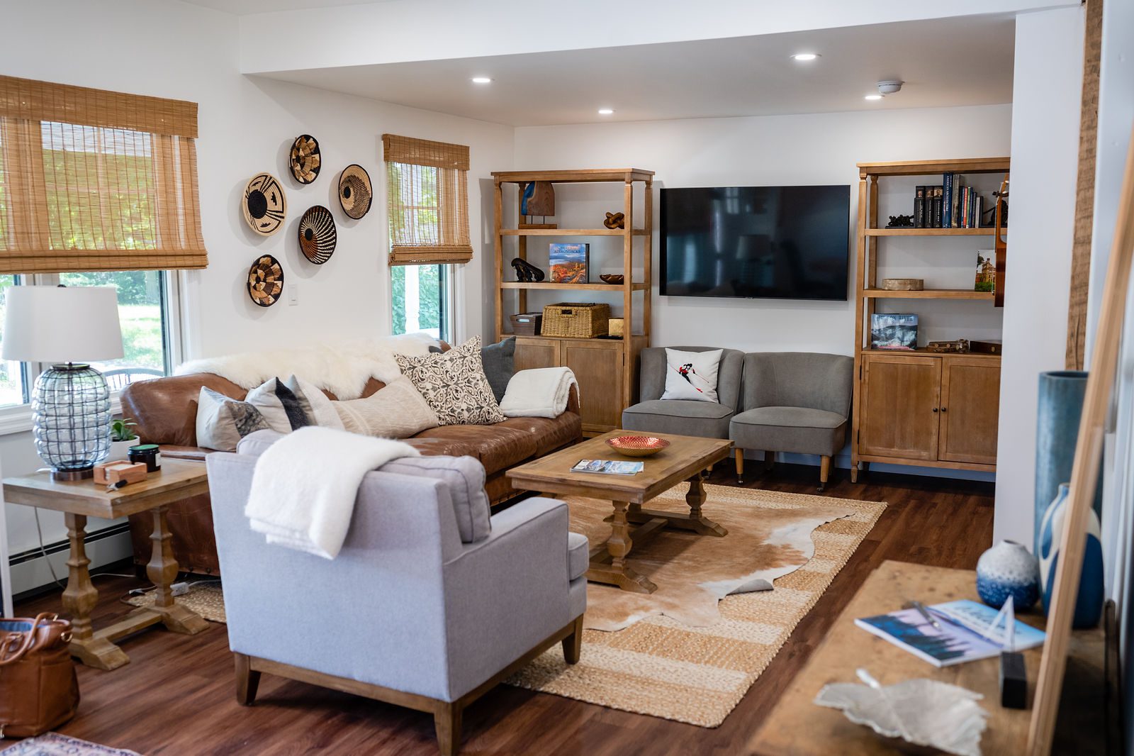 A living room with couches, chairs and tables. A living room with couches, chairs and tables.